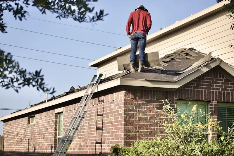 Professional roofer working on a residential roof in Franklin Springs
